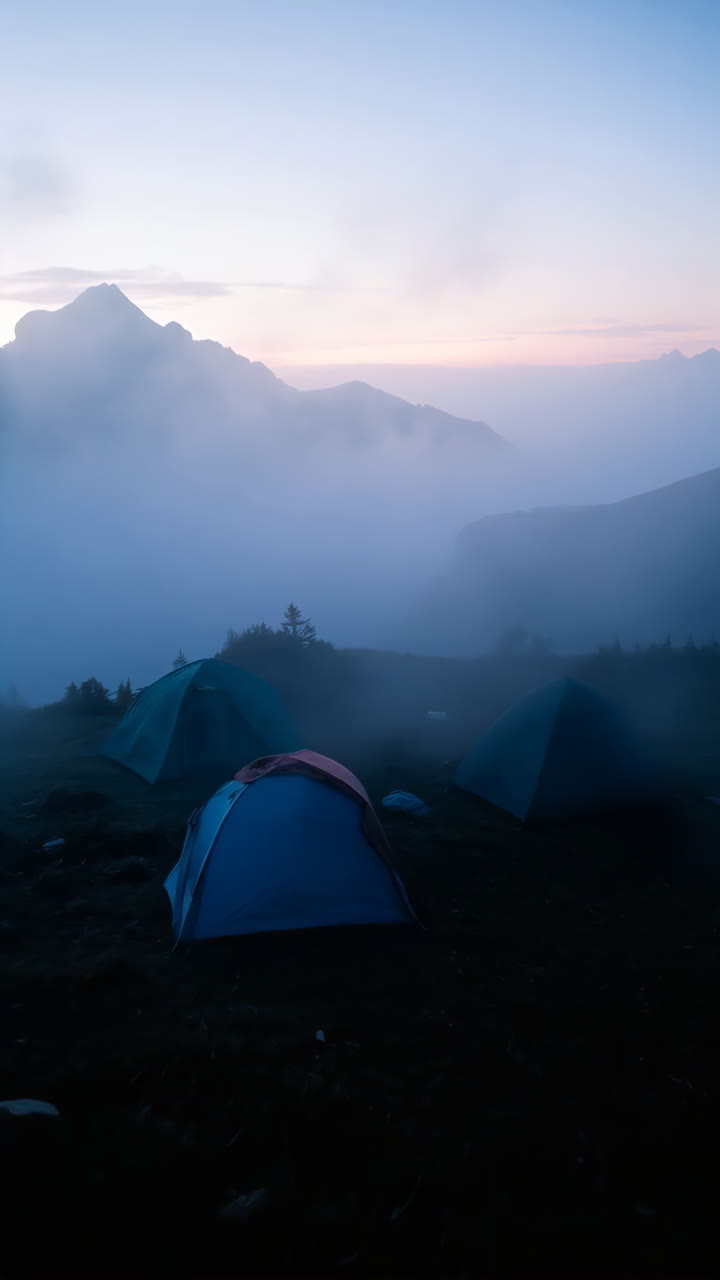 Tents in a Misty Mountain Landscape at Dawn
