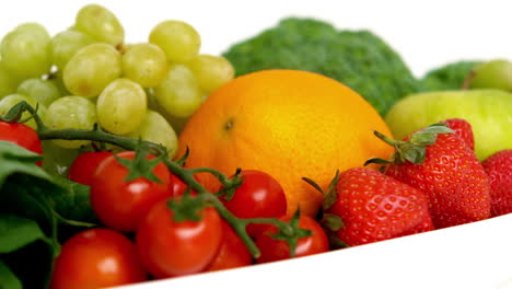 bowl of fruit and vegetables on white background