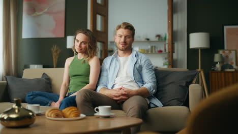 relaxed pair chilling sofa cozy home. family spending weekend sitting together