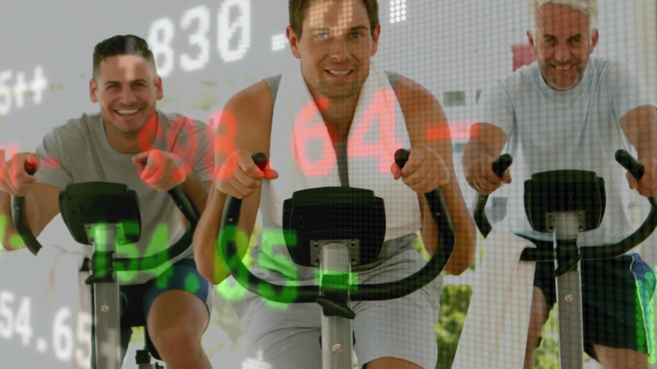 Group of three men pedaling exercise bikes in fitness studio, with floating digital workout data