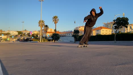 excited man carving skate park in estoril street on summer day