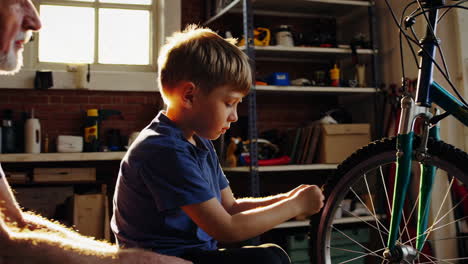 grandfather and grandson fixing a bike