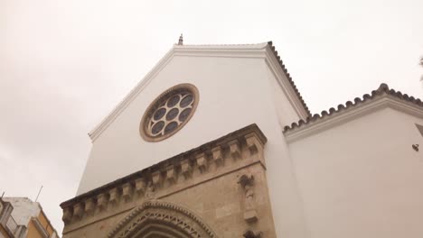 tilt up of historic santa catalina church in seville, spain on rainy day