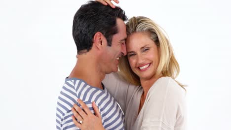 Happy-young-couple-embracing-each-other-against-white-background