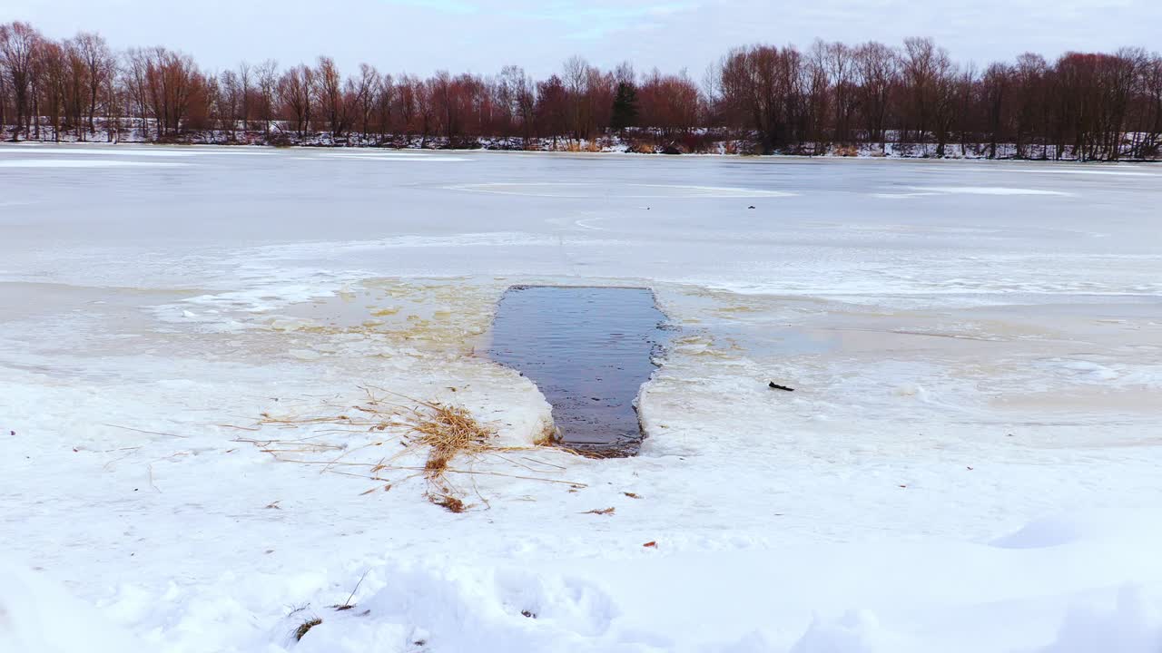 Frozen lake, open ice hole for cold water bathing to boost immune system health