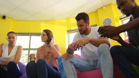 Low-angle-view-of-young-mixed-race-business-team-interacting-with-each-other-in-modern-office-4k