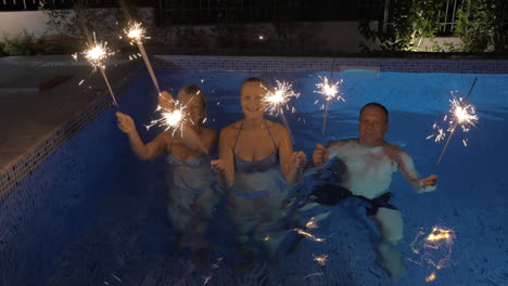 celebration with sparklers in the swimming pool