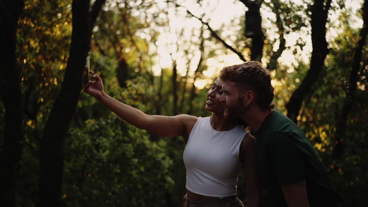 Couple taking selfie in a forest