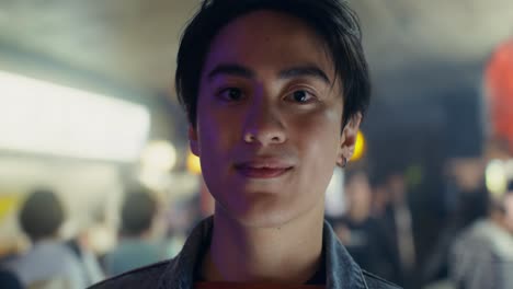 smiling young man at a nighttime gathering