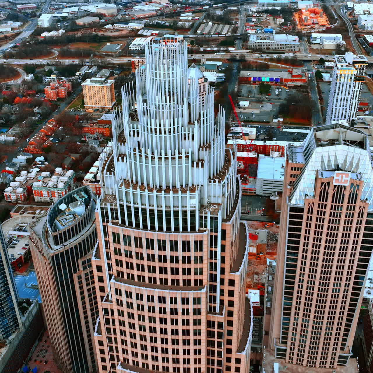 Distancing from the top of the beautiful skyscraper. Aerial perspective on Charlotte downtown, North Carolina, USA.