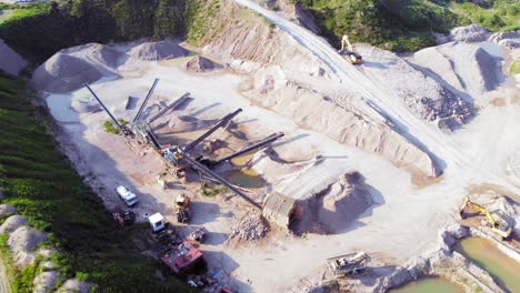 aerial orbit shot of quarry and heavy machinery