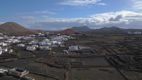 village with only white houses in volcanic landscape