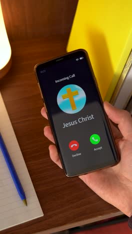 concept of jesus christ calling you on your smartphone. vertical shot.