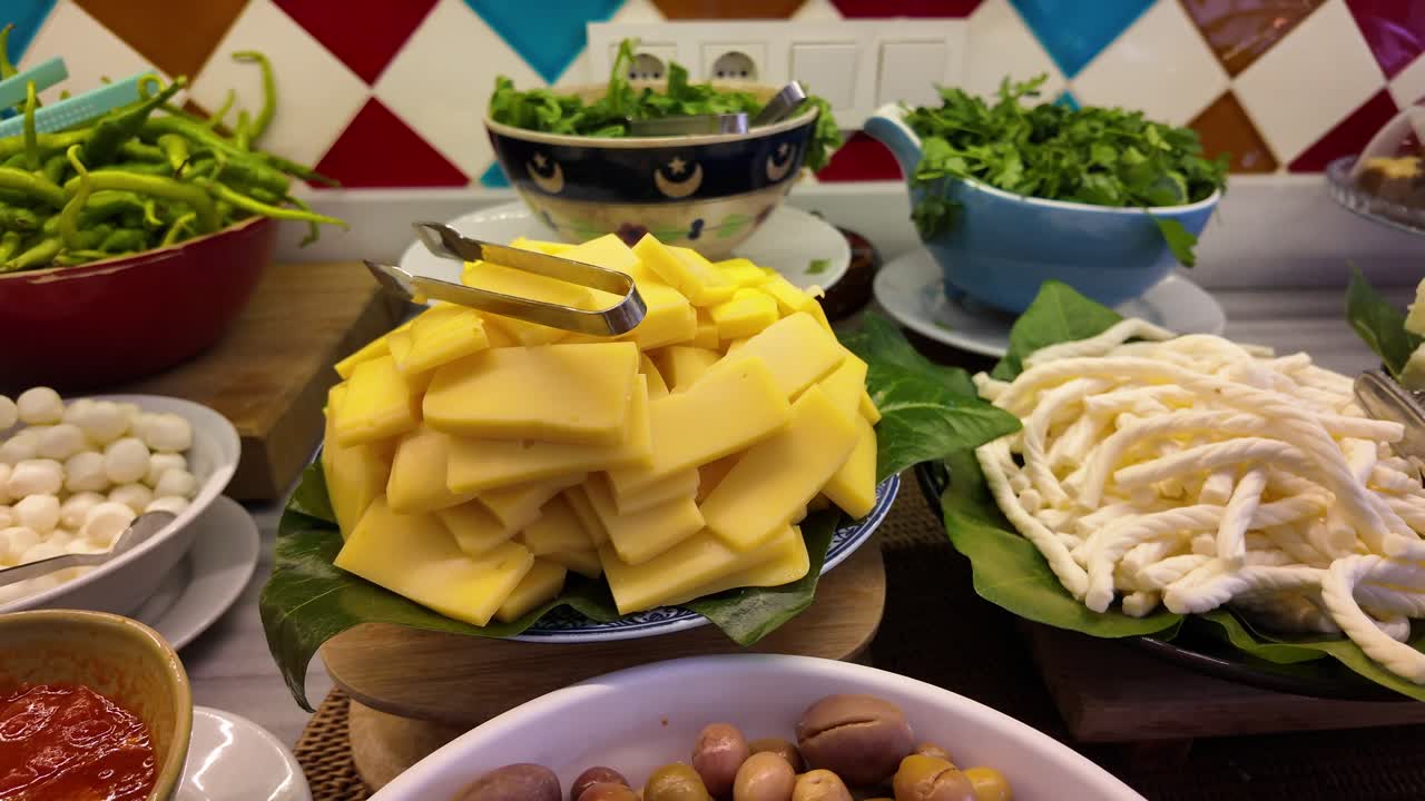 Buffet with Cheese, Salad, Olives, and Peppers