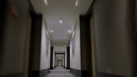 timelapse of moving forward in empty light hotel corridor