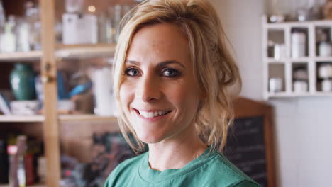 portrait of confident woman working in workshop on upcycling and craft projects