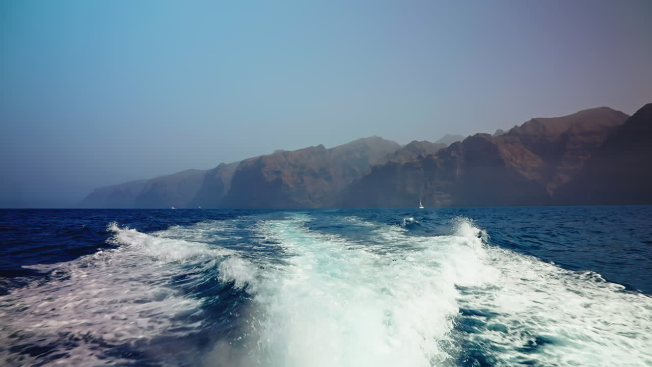Boat tour along the volcanic rocky coastline of Tenerife, Canary Islands, Spain.
