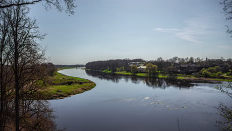 Small-town-and-curvy-river-on-sunny-day,-time-lapse-view