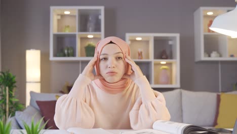 young girl in hijab being unhappy and disappointed.