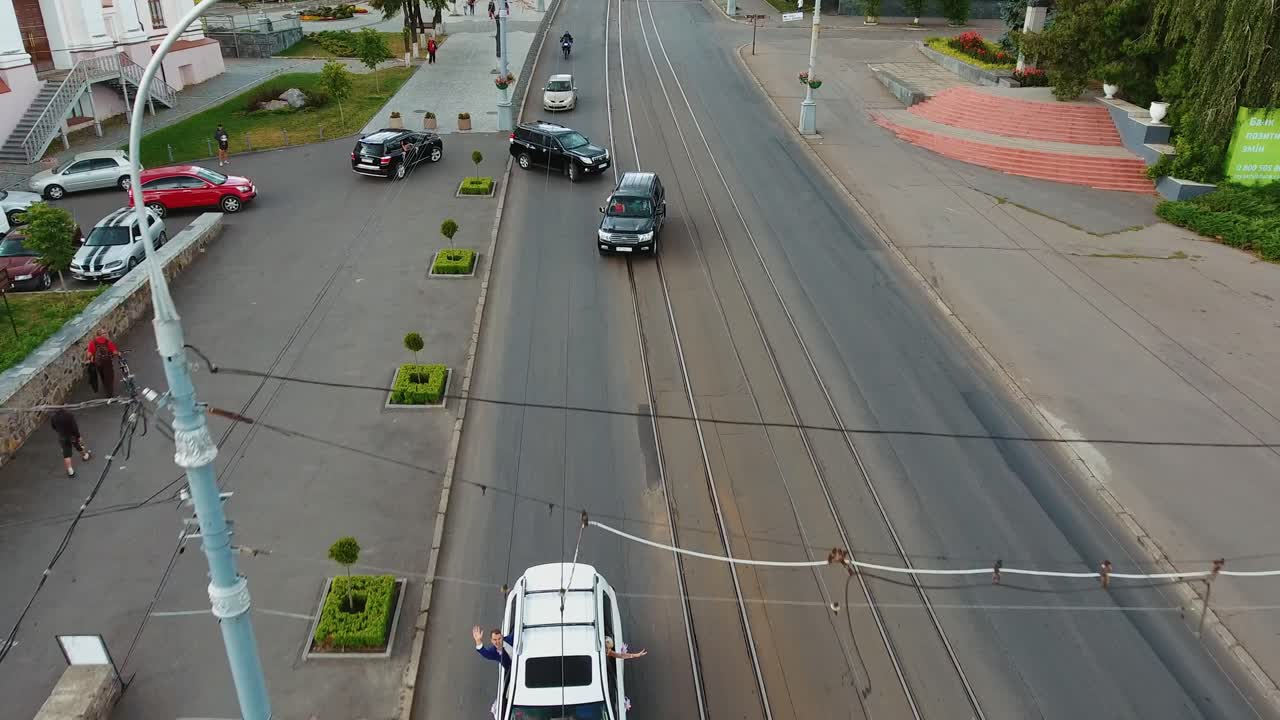 Classic wedding car procession. Car wedding procession drives through city