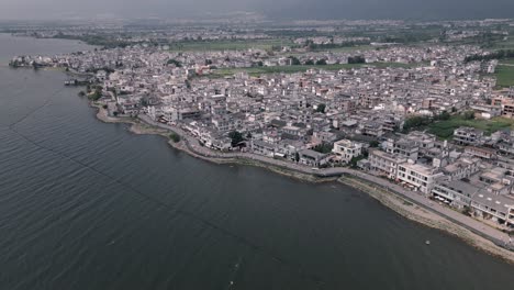 The-aerial-footage-shows-an-aerial-top-down-view-of-the-S-Curve-along-the-western-coast-of-Erhai-Lake-in-Dali,-Yunnan-Province-in-China