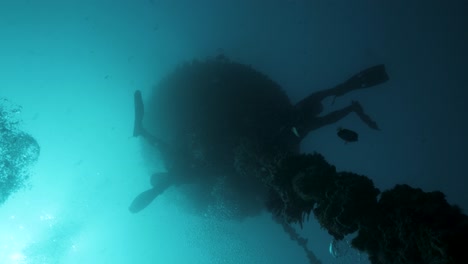 commercial scuba divers work on an infrastructure project deep below the ocean surface