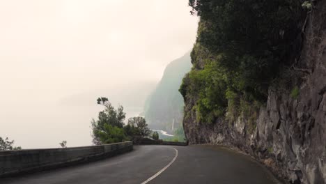 coastal road through mountains with fog