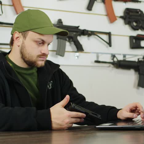 man behind a counter in an arms store