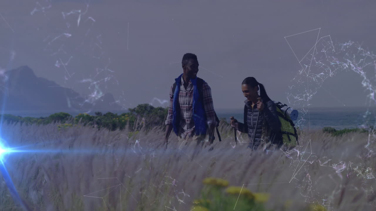 Two hikers traversing coastal grassland, showing animated health metrics and heart rate chart