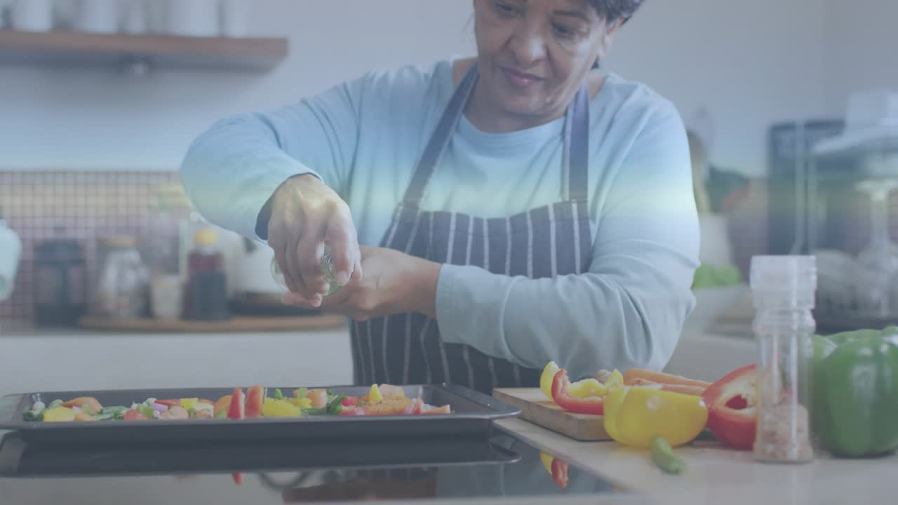 Home cook grabbing seasoning, sprinkling vegetables in kitchen while hologram mapping distribution