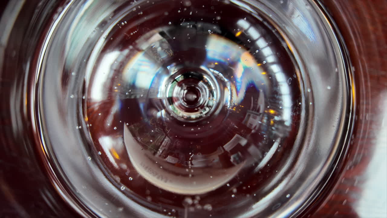 Slow motion pouring of mineral water on a glass close pu