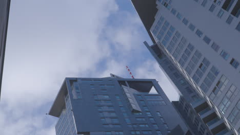 Skyscraper-roofs-against-a-backdrop-of-moving-clouds