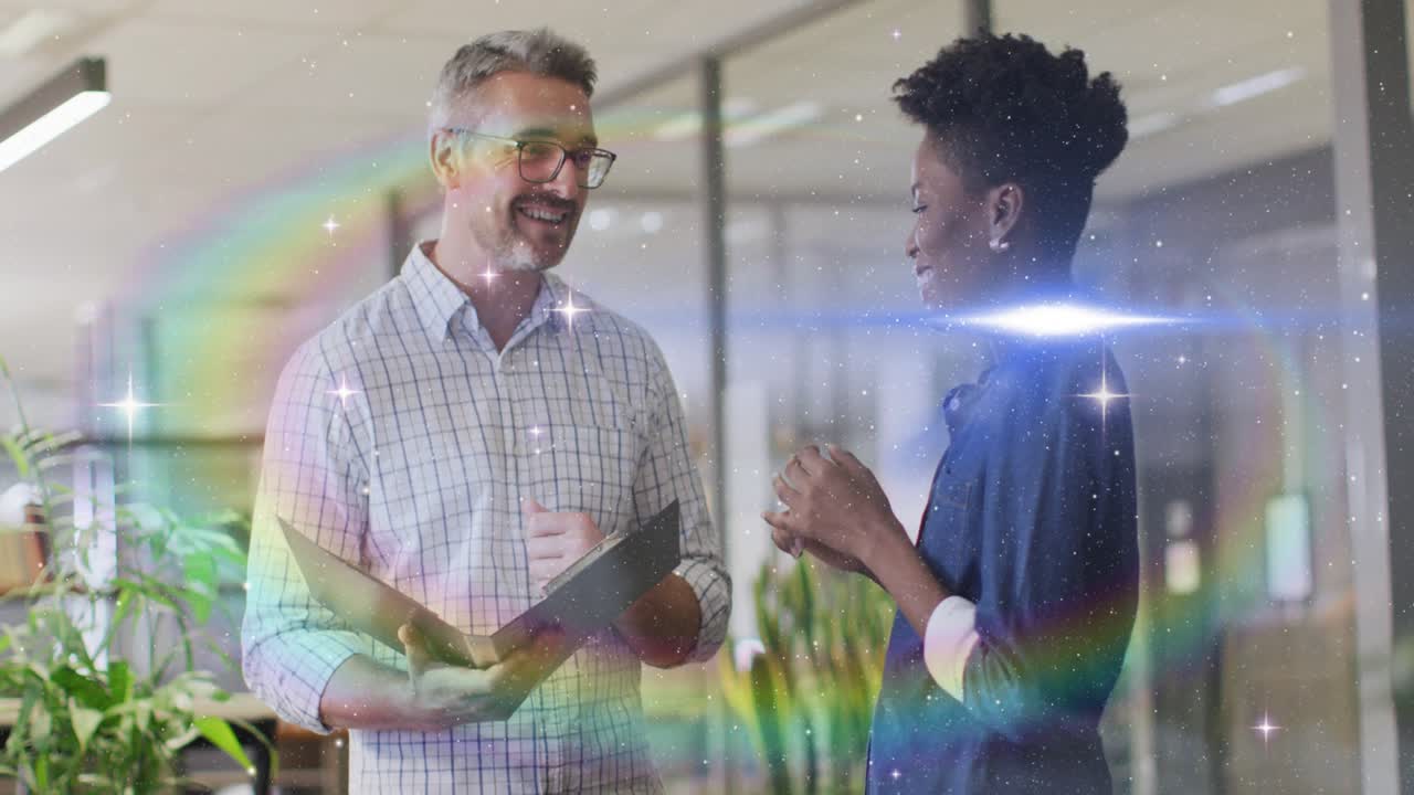 Manager pointing at folder initiating rainbow flares rising in business, woman nodding both smiling