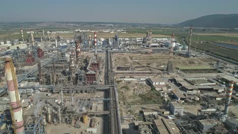 Aerial-footage-of-a-large-scale-Oil-refinery-with-smoke-stacks-and-petroleum-storage-tanks