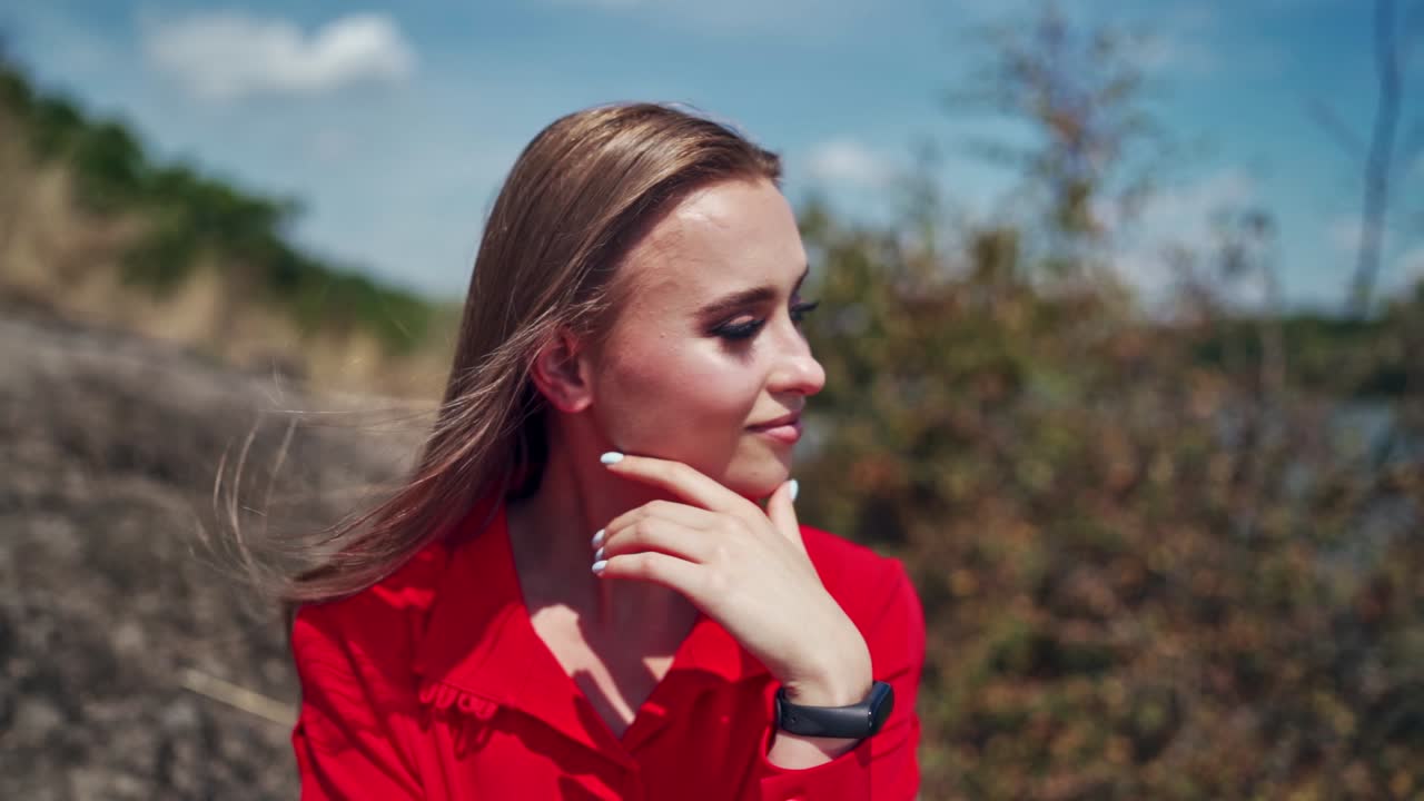Portrait of young model in nature. Face of attractive woman posing to camera outdoors. Beautiful girl on blur natural background.
