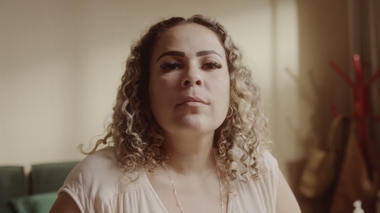 Portrait of a Woman with Curly Hair Looking at Camera