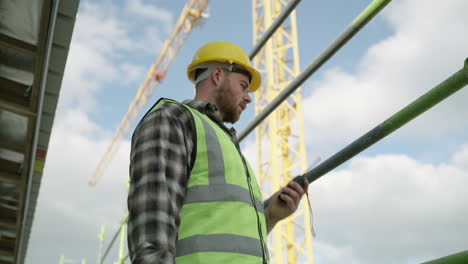 a young man using a walkie talkie while working