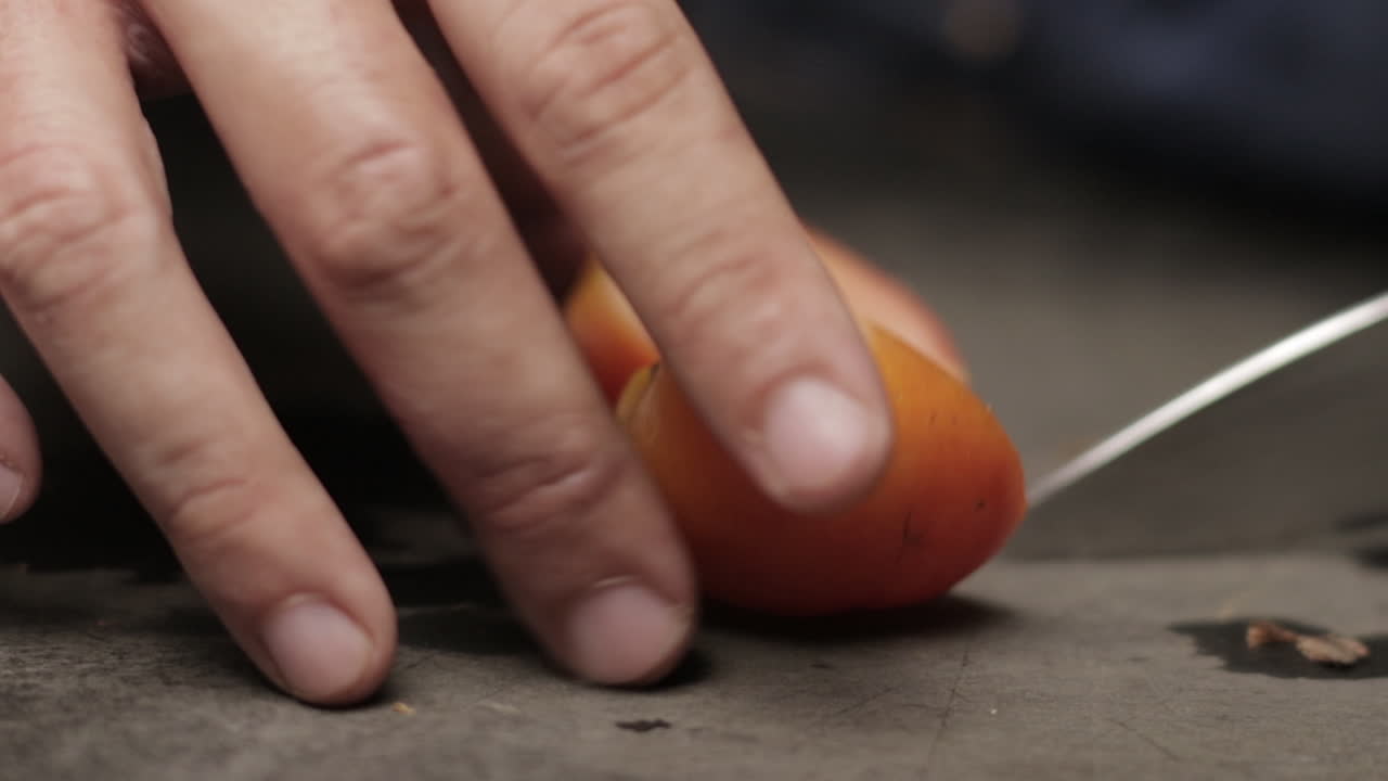 Hands Cutting Fresh Ripe Tomato In Slow Motion. close up