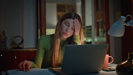 Accountant worried work mistake looking laptop late evening home close up.