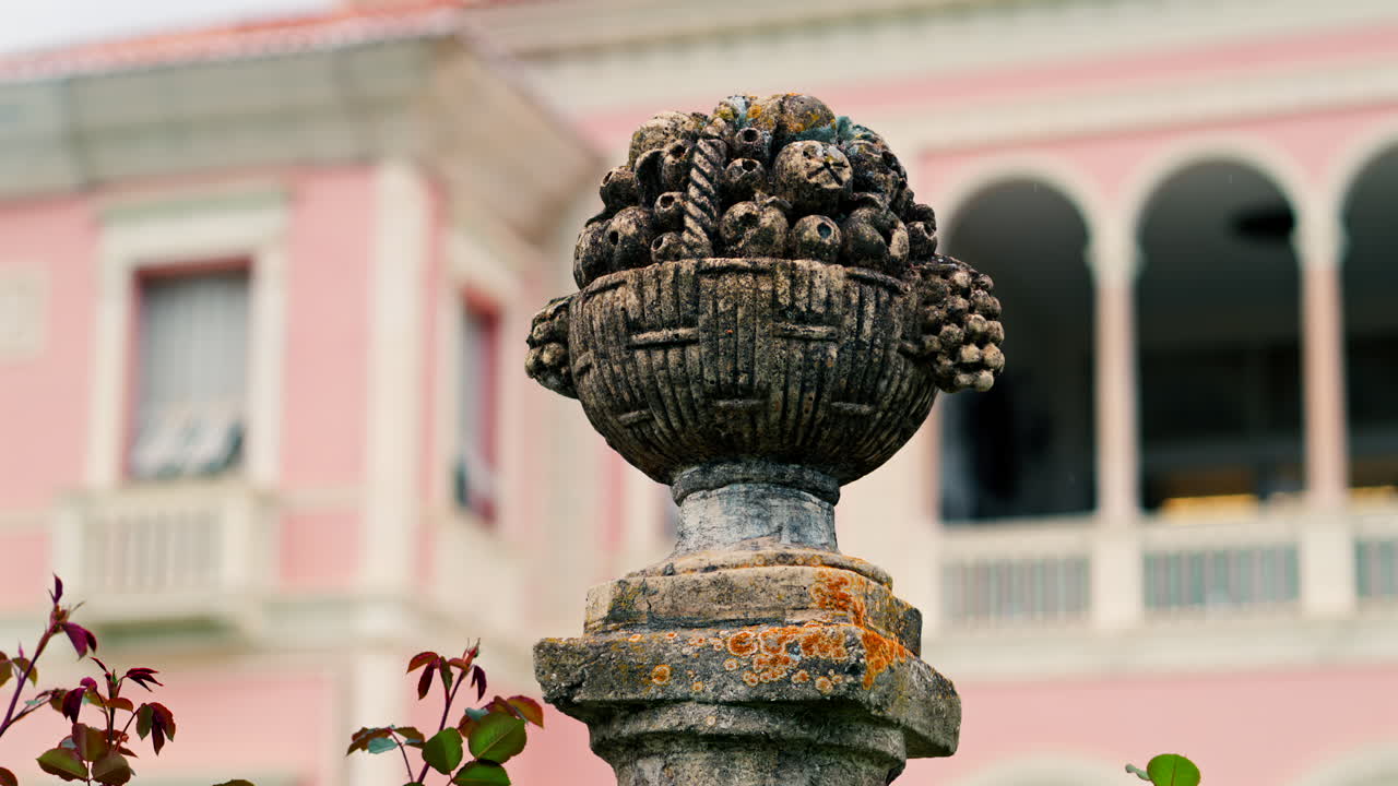 Close up of a decorative stone pillar in the courtyard of Villa Ephrussi de Rothschild with a blurred view on the background