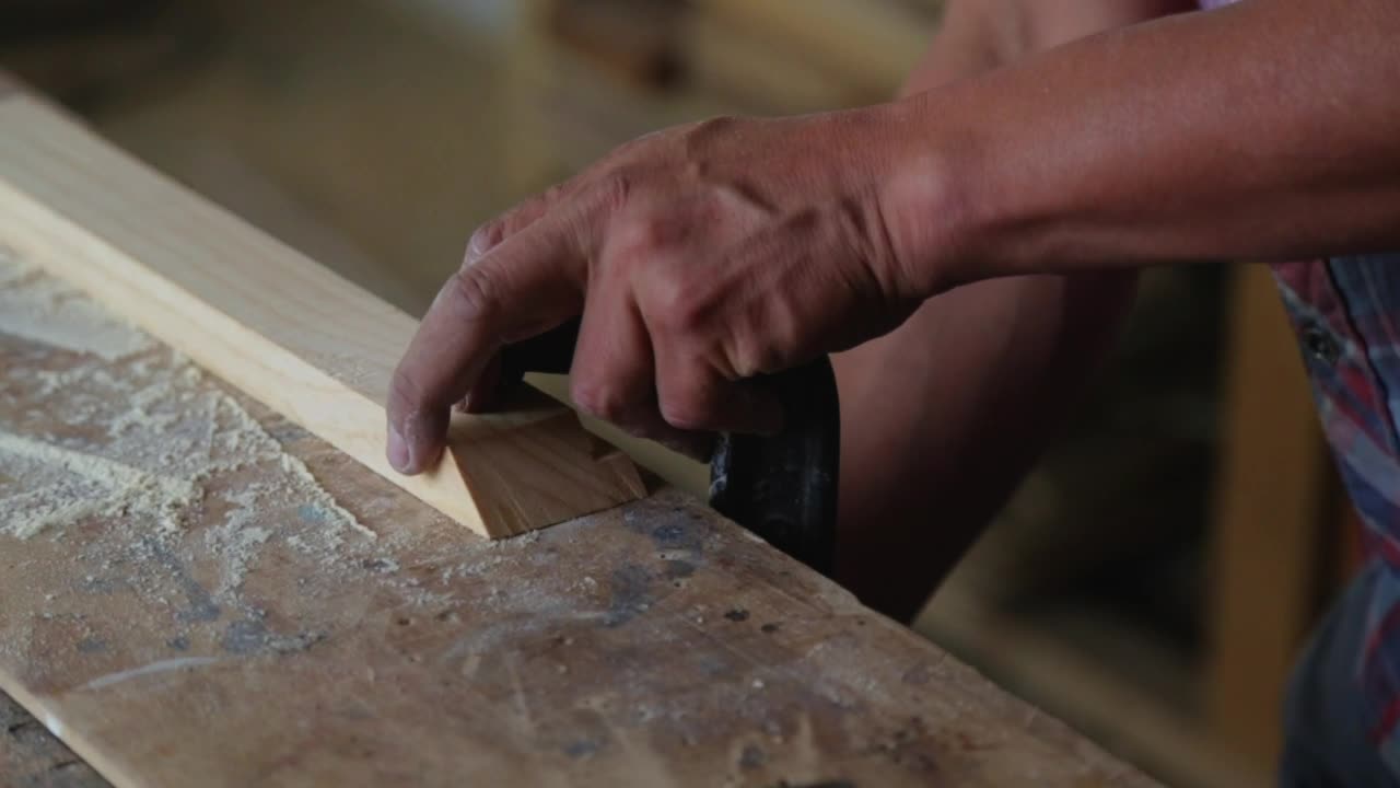 Carpenter sanding a piece of wood