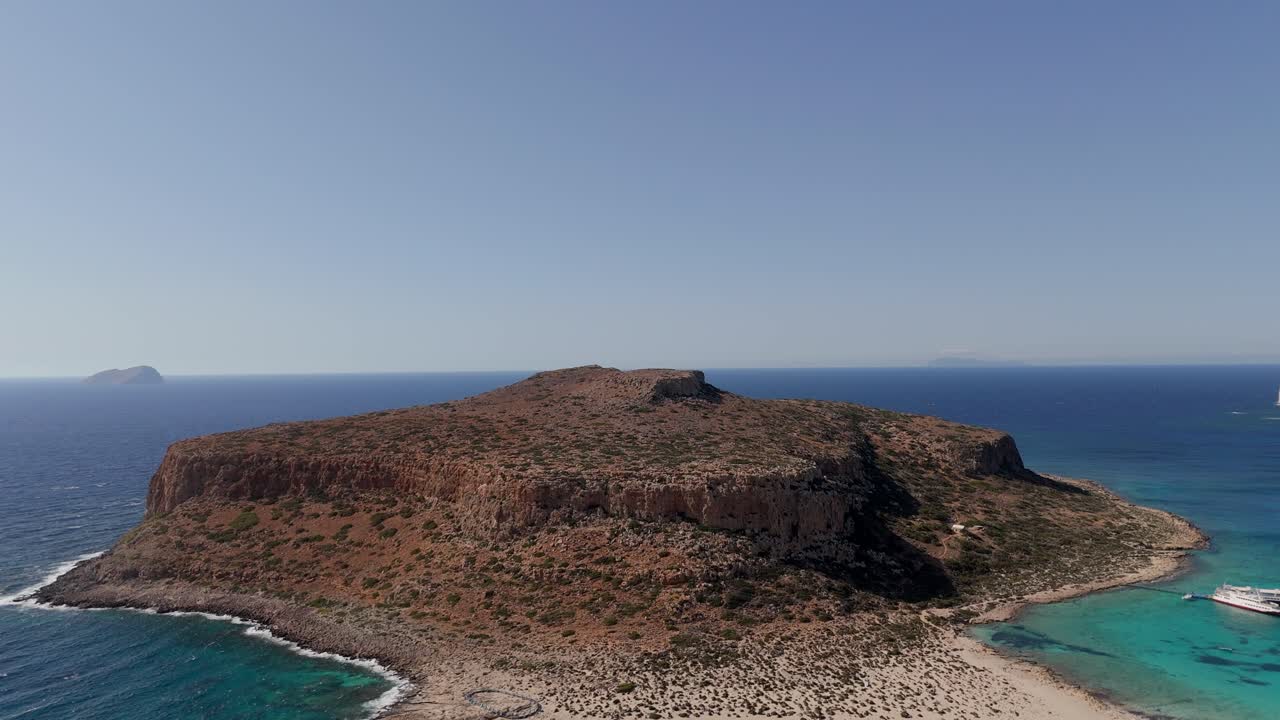 Aerial - rugged rocky island and blue sea at Balos Lagoon, Crete, Greece