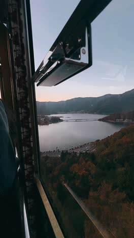 autumn view of a lake from a train window in japan