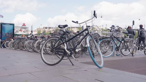 multiple bicycles parked on sidewalk near street in copenhagen, denmark
