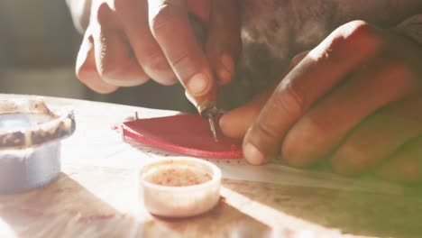 close up view of man working by hand in factory