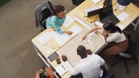 Happy-diverse-architects-looking-at-architectural-models-at-office