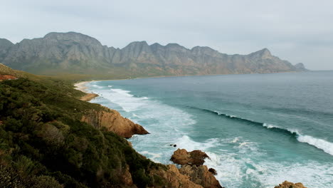 scenic kogel bay on clarence drive, surrounded by hottentots holland mountains