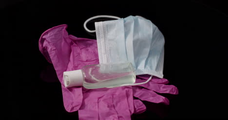 purple protective mask isolated on black background rotating medical mask protective gloves 1