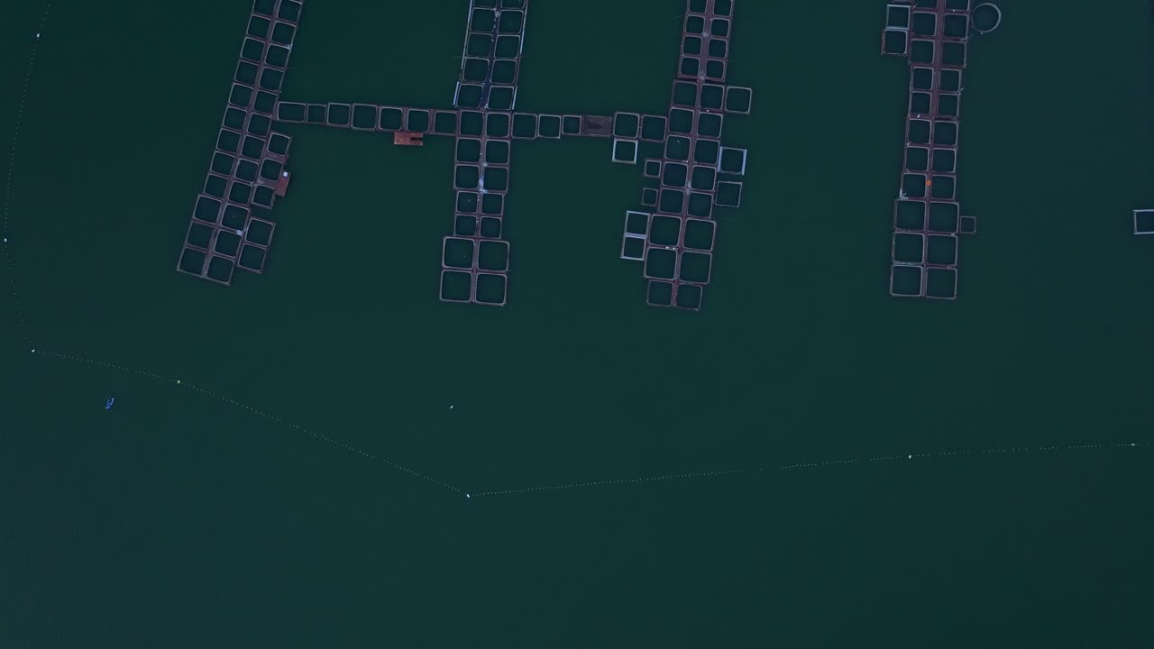 Serene sunset over lake with aquaculture structures, Bulgaria