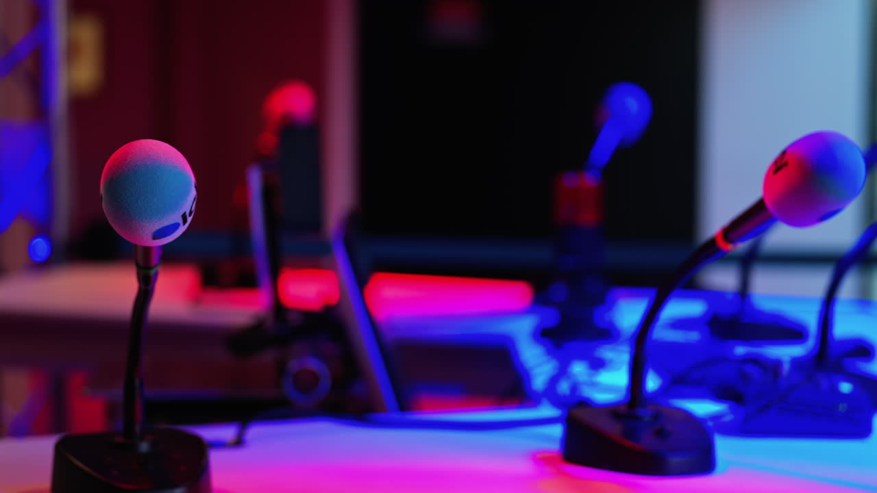 Cannes, France - March 2, 2025: Close up of a microphone on a blurred background with blue and red lights at the International Games Festival